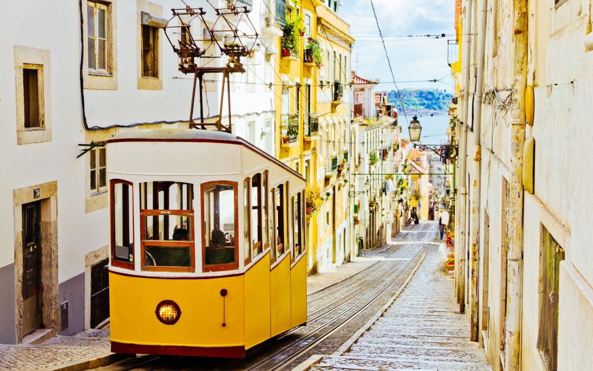 yellow and white tram on road during daytime