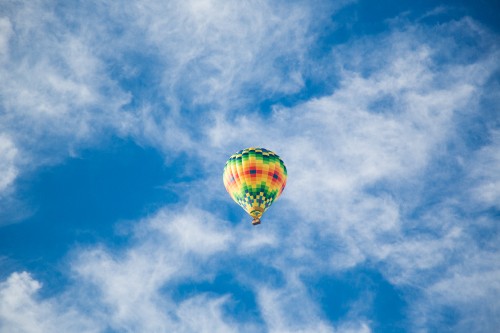 Image yellow hot air balloon in mid air under blue sky during daytime