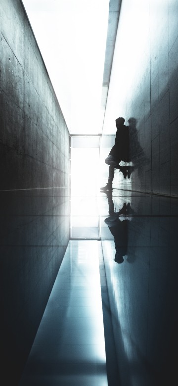 Image man in black jacket walking on hallway