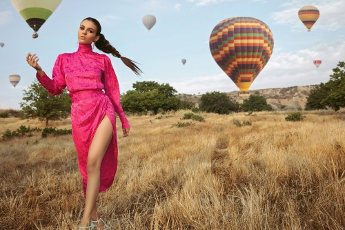 Image woman in purple dress holding hot air balloon