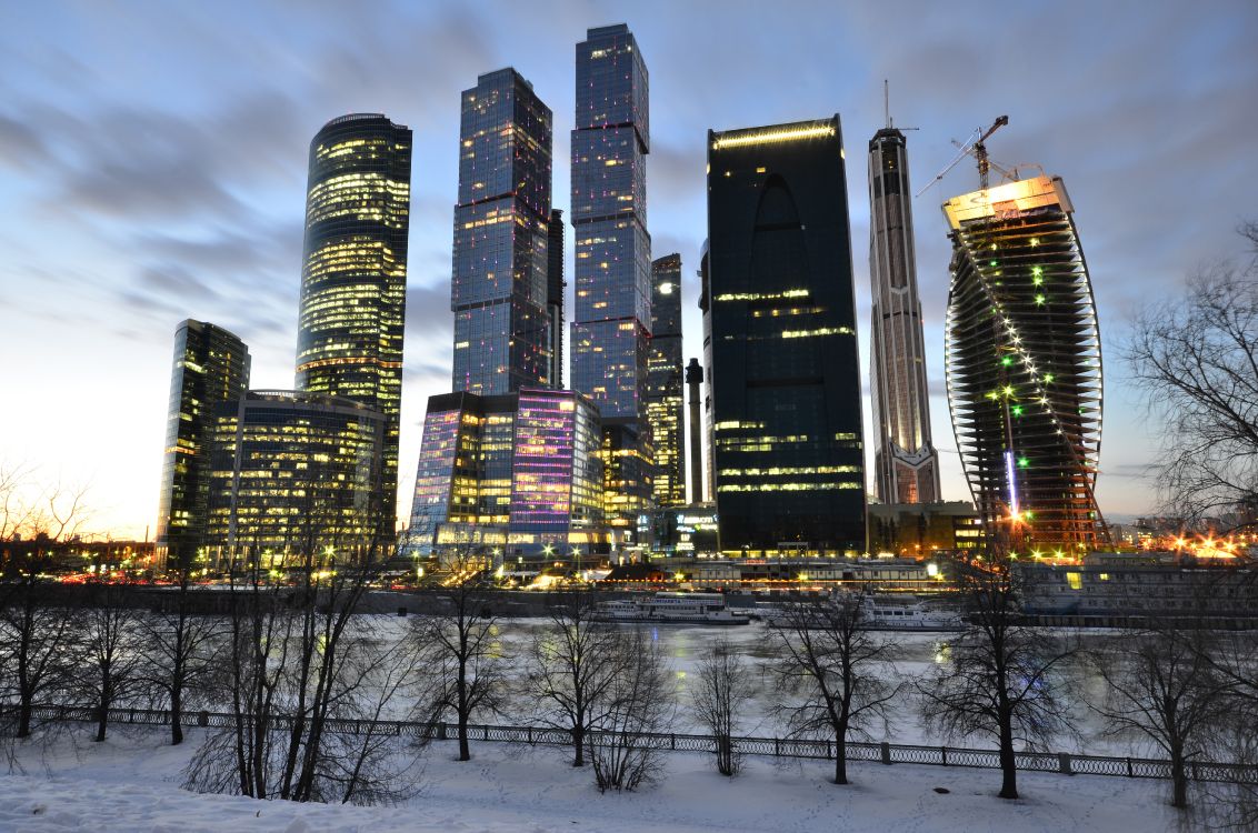 city buildings under blue sky during night time