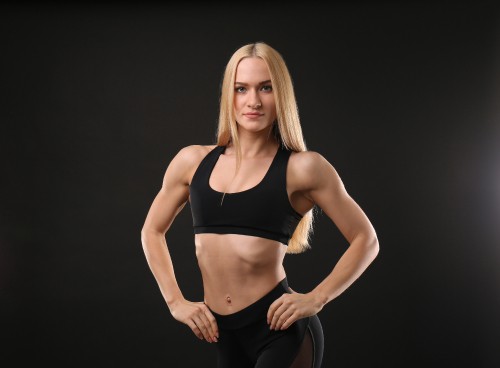 Image woman in black sports bra and black leggings