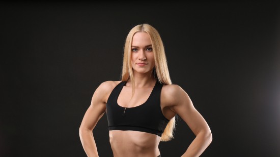 Image woman in black sports bra and black leggings