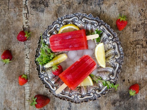 Image red and yellow ice cubes on silver round tray