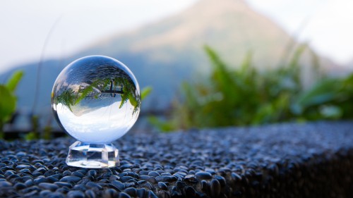 Image clear glass ball on black and white stone