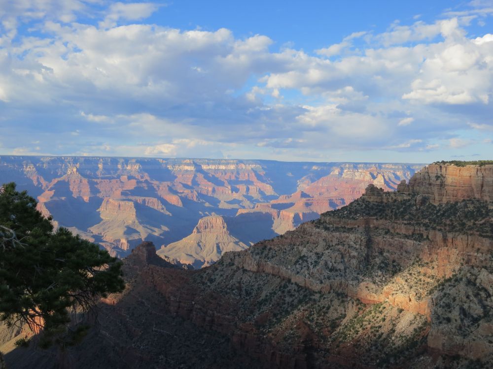 brown and gray mountains under white clouds and blue sky during daytime