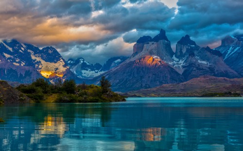 Image lake near mountain under cloudy sky during daytime