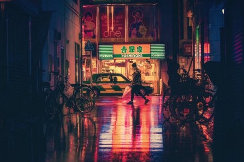 Image people walking on sidewalk during night time