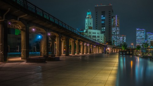 Image people walking on sidewalk during night time