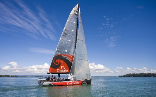 Image white and red sail boat on sea under blue sky during daytime