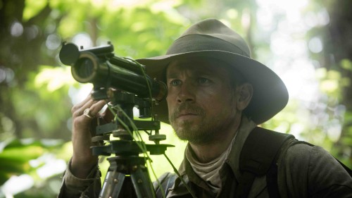 Image man in green and brown camouflage uniform holding black camera