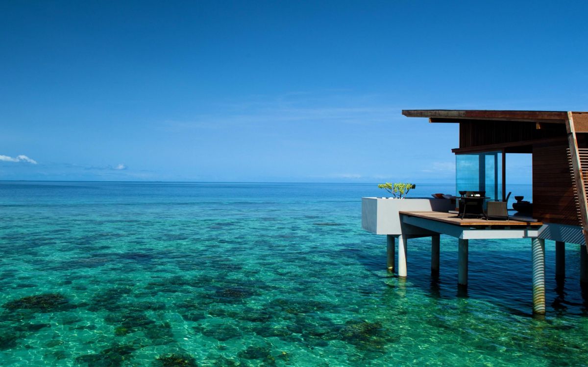 brown wooden dock on blue sea under blue sky during daytime