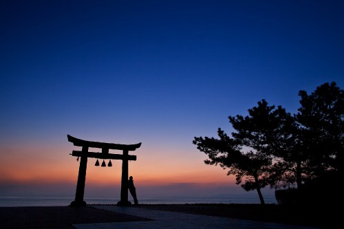 Image silhouette of wooden bench on beach during sunset