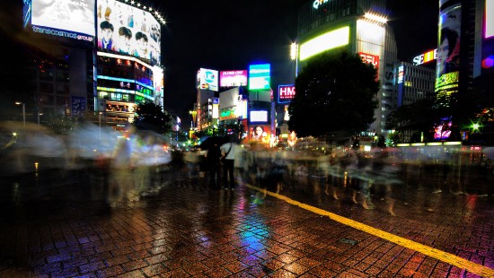 Image people walking on sidewalk during night time