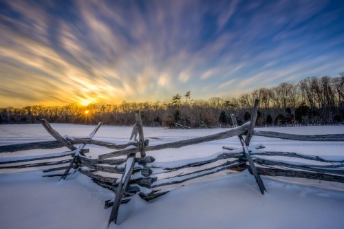 Image brown wooden fence on green grass field during sunset