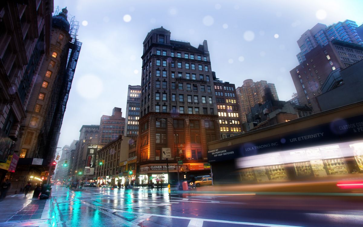 city buildings with lights turned on during night time