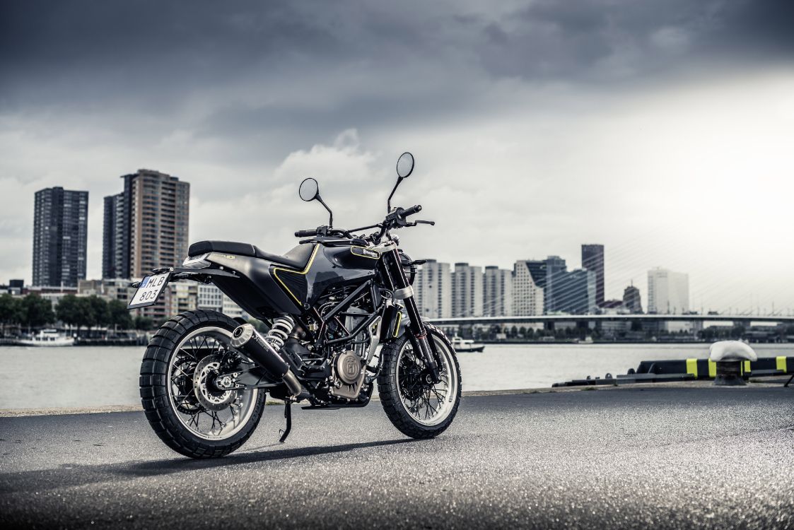 black motorcycle on gray asphalt road during daytime