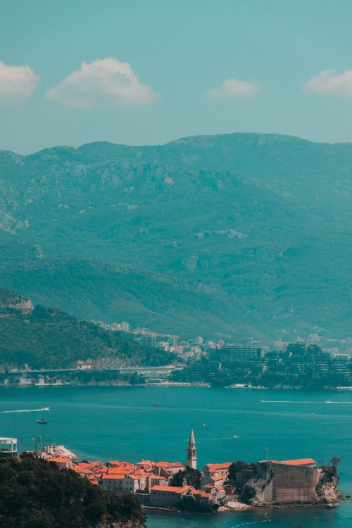 green mountains near body of water during daytime