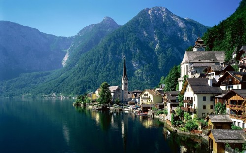 Image white and brown concrete building near body of water during daytime