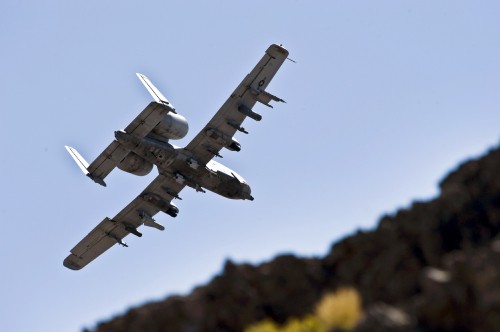 Image white and black airplane flying in the sky during daytime