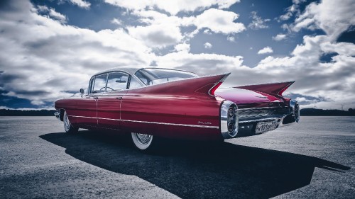 Image red mercedes benz coupe on gray asphalt road under blue and white sunny cloudy sky during