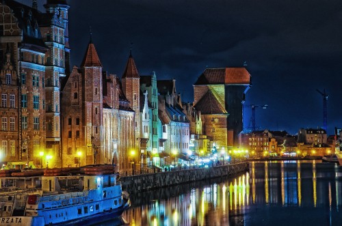 Image brown concrete building near body of water during night time