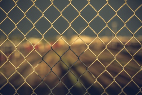 Image grey metal fence with yellow light