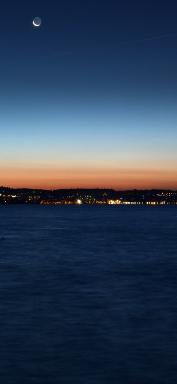 Image body of water near mountain during sunset