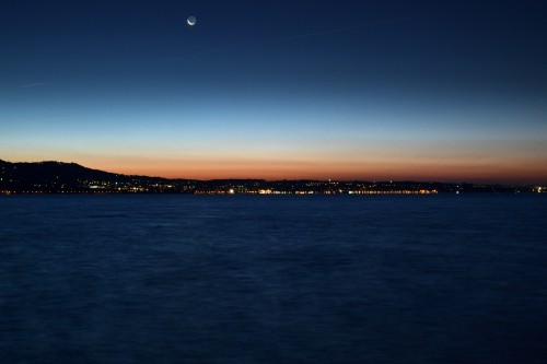 Image body of water near mountain during sunset