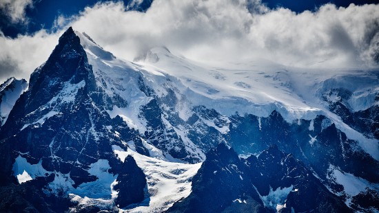 Image snow covered mountain under cloudy sky during daytime