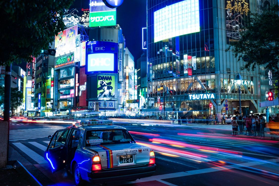 cars on road near buildings during night time