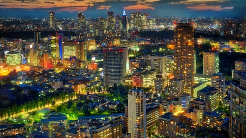 Image city with high rise buildings during night time