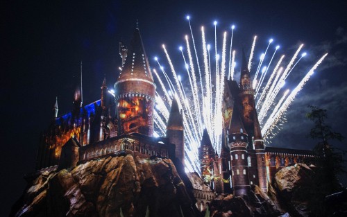 Image brown and blue castle with lights during night time