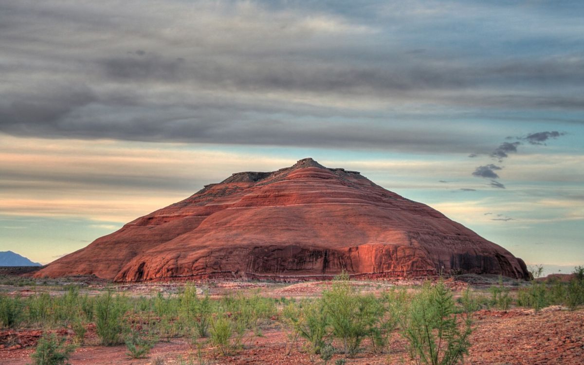 brown mountain under cloudy sky during daytime