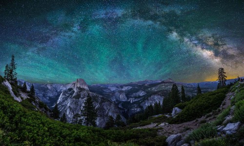 Image green and white mountain under green sky