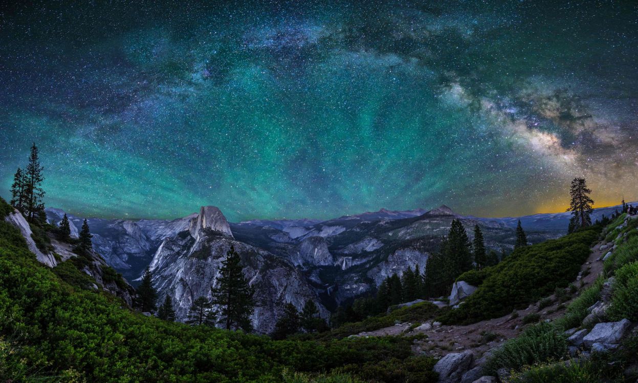 green and white mountain under green sky