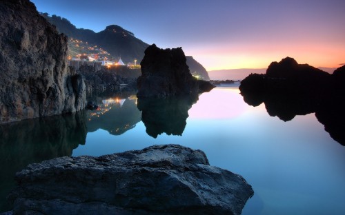 Image body of water near mountain during daytime