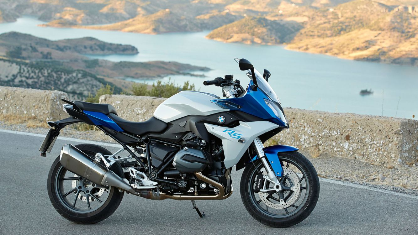 blue and black sports bike on brown sand during daytime