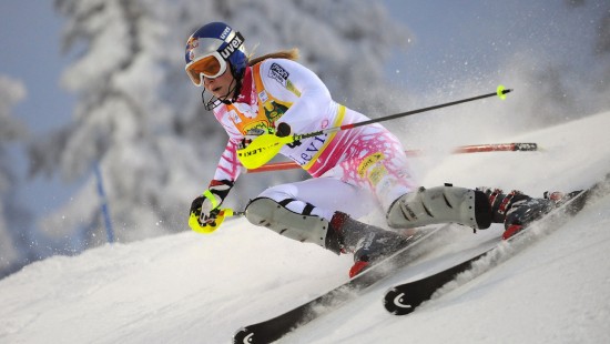 Image person in white and pink jacket riding on white snow board during daytime