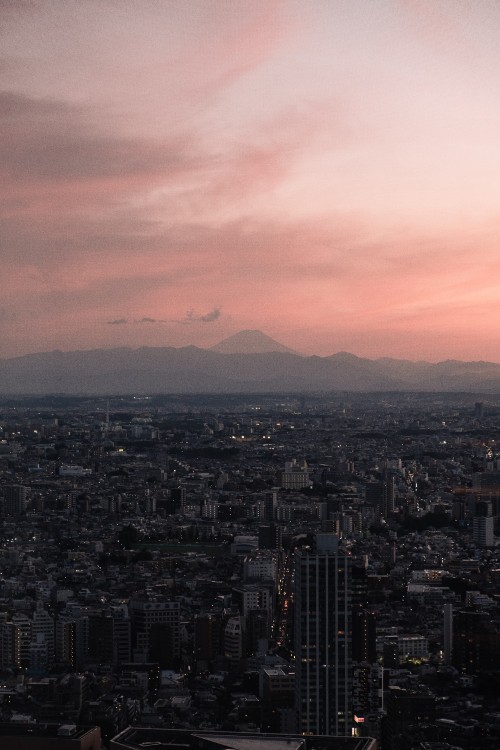 Image aerial view of city buildings during sunset