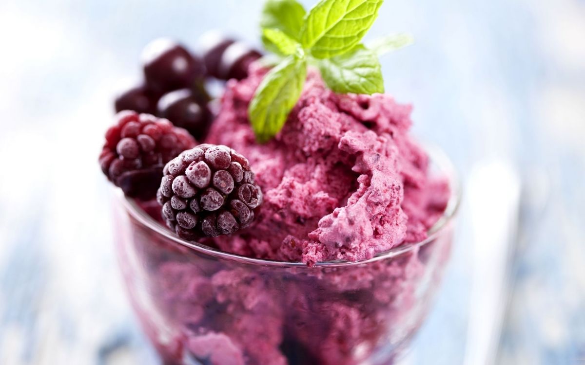 pink ice cream with green leaf on clear glass cup