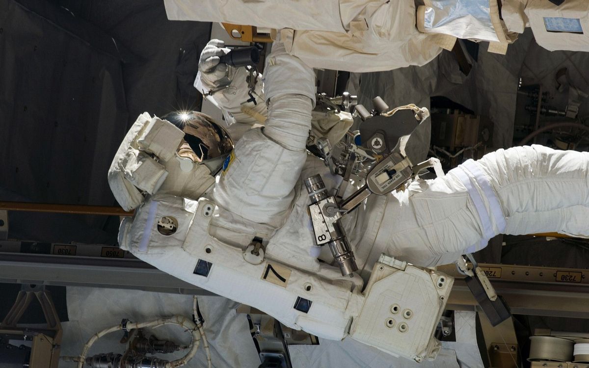 person in white shirt and pants wearing helmet