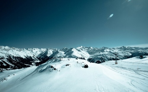 Image snow covered mountain under blue sky during daytime