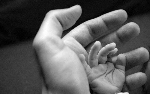 Image grayscale photo of babys feet