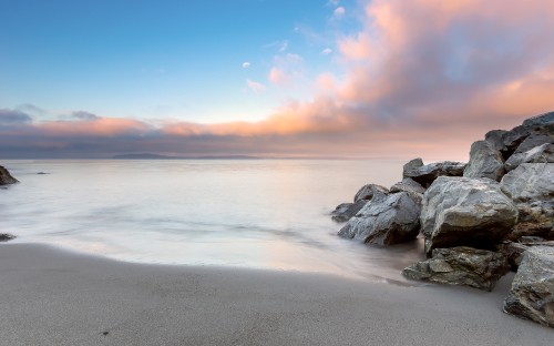 Image gray rocks on seashore during sunset