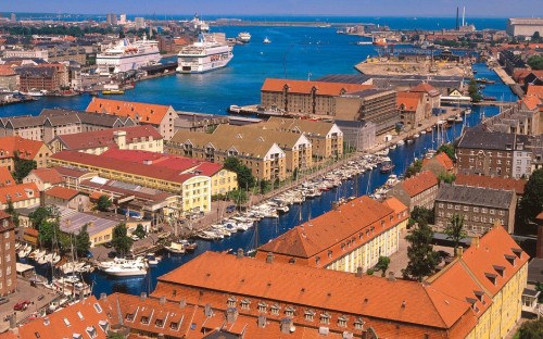 Image aerial view of city buildings near body of water during daytime