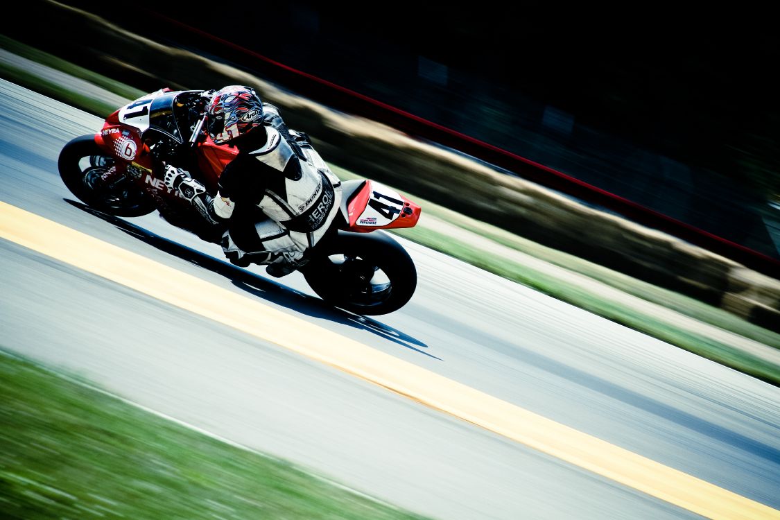 Man in Red and White Racing Suit Riding on Sports Bike. Wallpaper in 5184x3456 Resolution