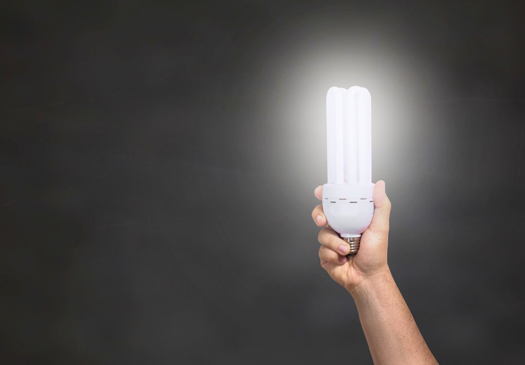 person holding white plastic container