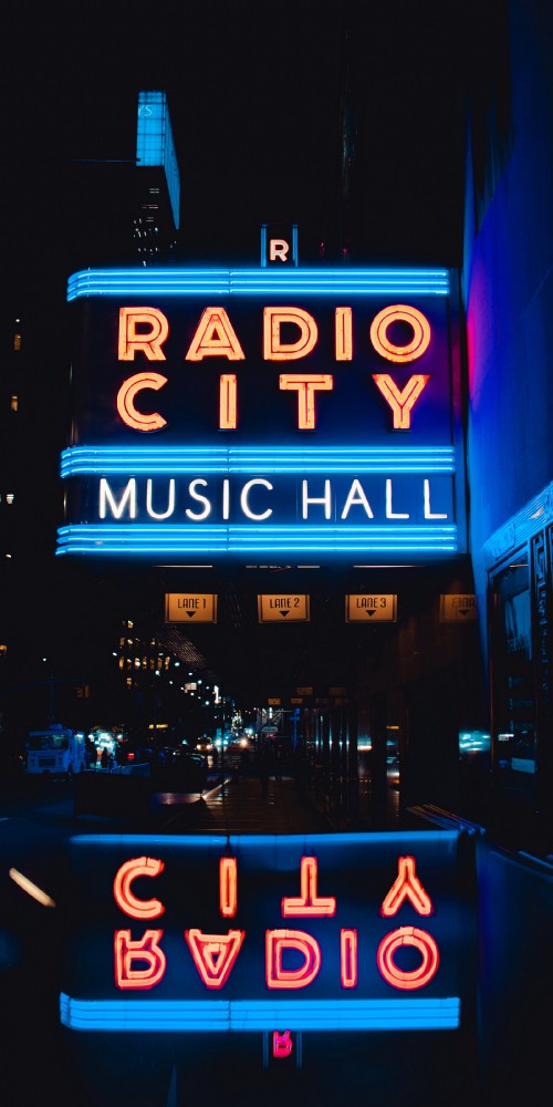 Image rockefeller center, radio city music hall, neon sign, text, building