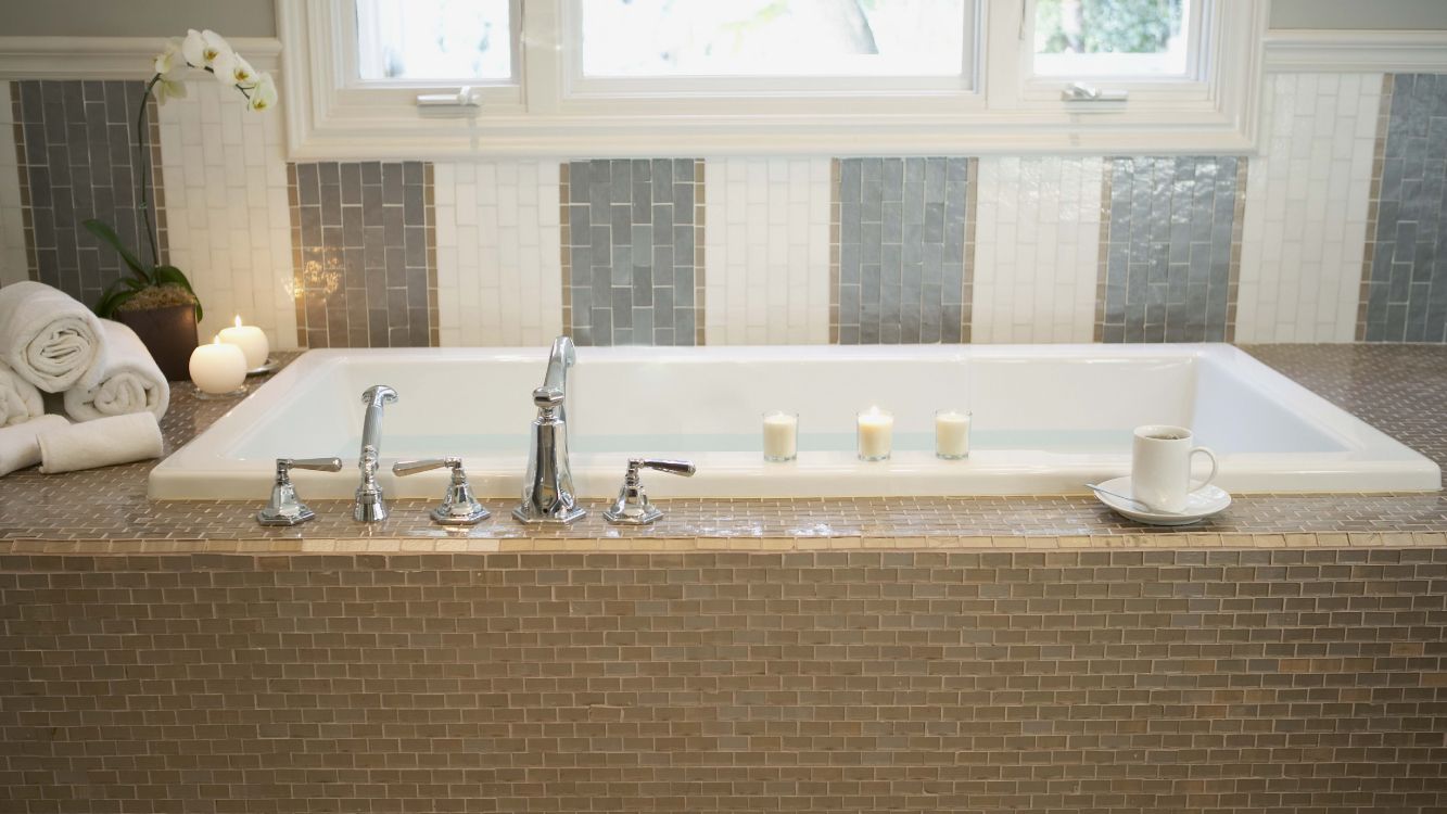 stainless steel faucet on brown and white ceramic sink